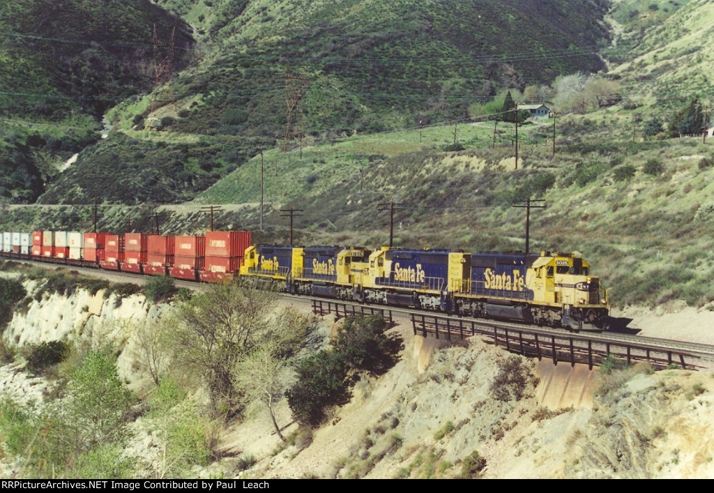 Heavy eastbound stack train comes up the grade.